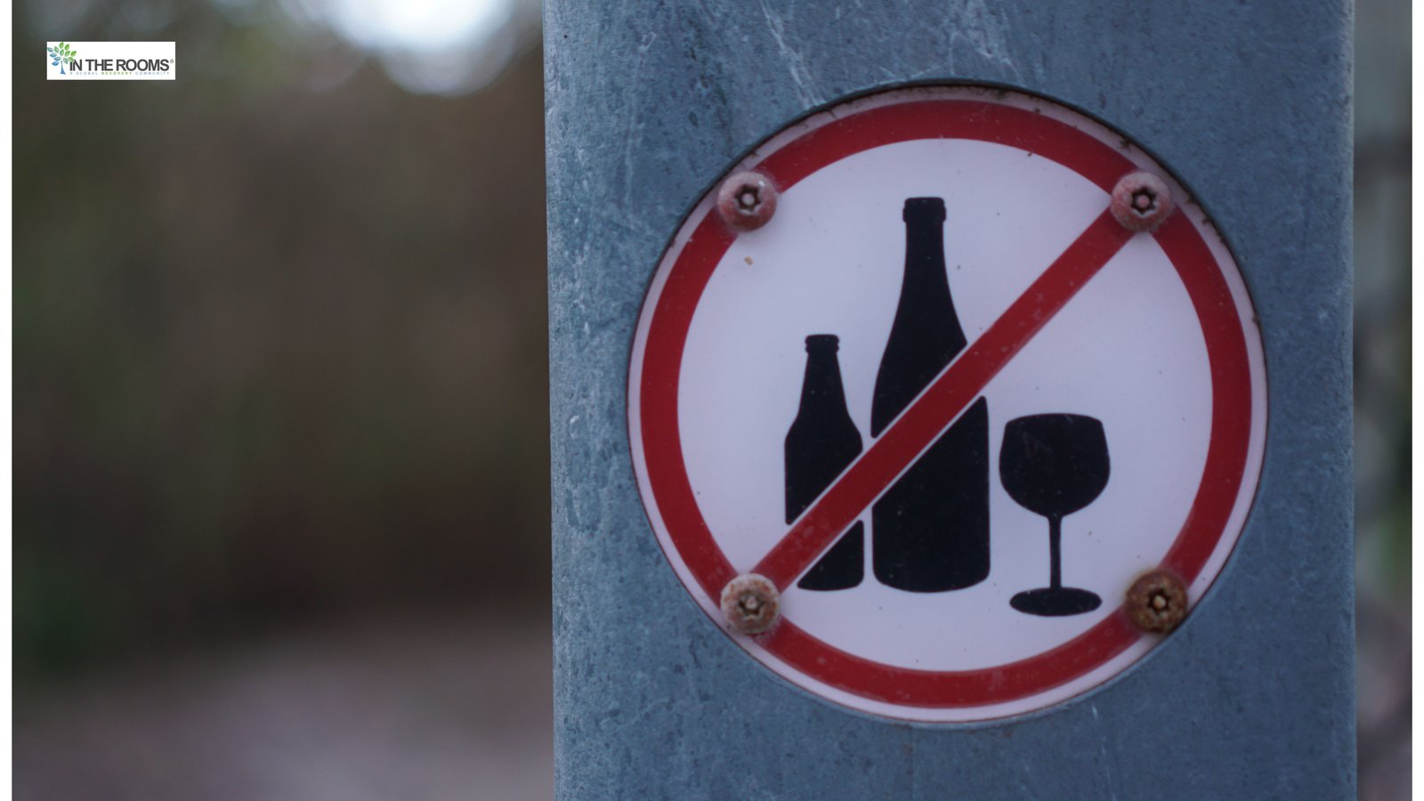 A sign showing bottles and a wine glass crossed out, symbolizing stopping alcohol use and choosing sobriety