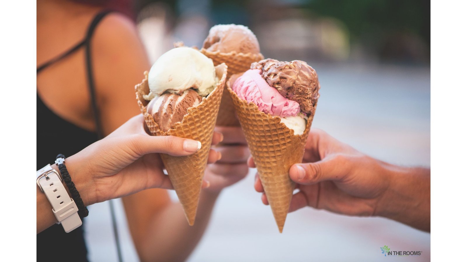 Three people hold colorful ice cream cones together, celebrating friendship, connection, and the simple joys that support recovery.