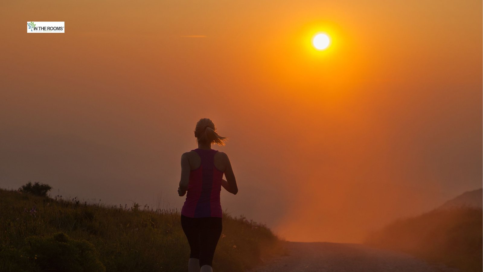 Person jogging on a trail at sunrise, symbolizing endurance and steady progress in recovery.