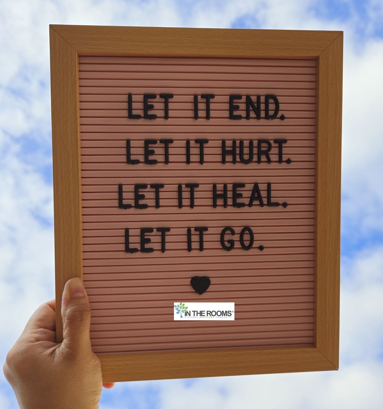A hand holds a letter board displaying the words “Let it end. Let it hurt. Let it heal. Let it go,” symbolizing acceptance, healing, and the decision to seek recovery beyond willpower.