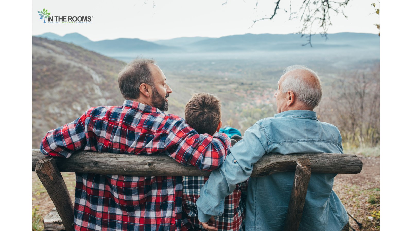 Three generations sitting together on a bench overlooking a landscape, symbolizing generational perspectives on drinking.