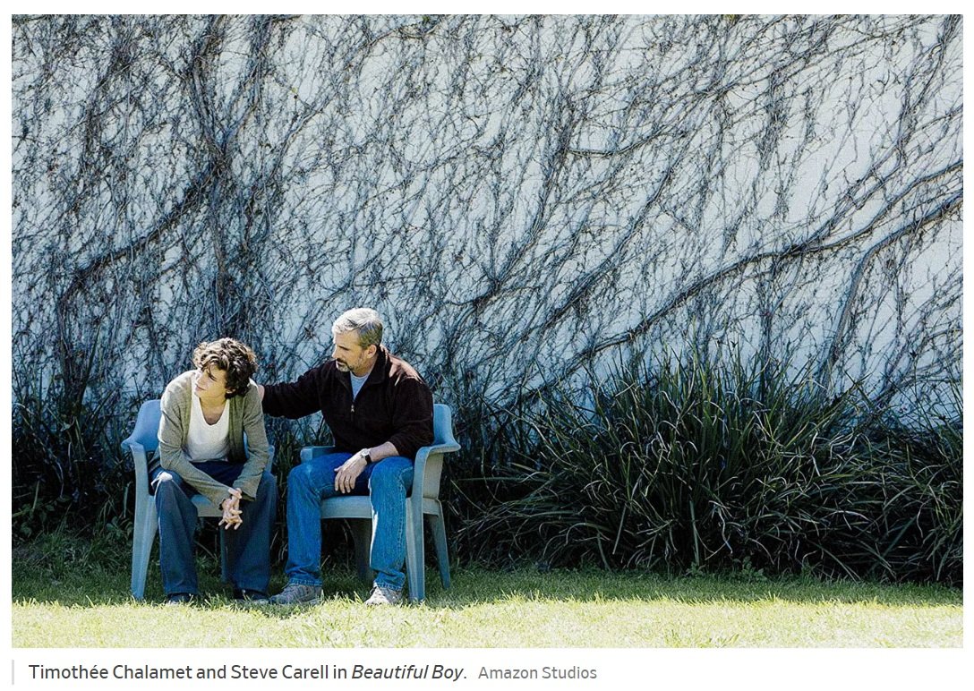 A distressed person sits outdoors while a supportive companion places a reassuring hand on their shoulder, symbolizing compassion and support during recovery.